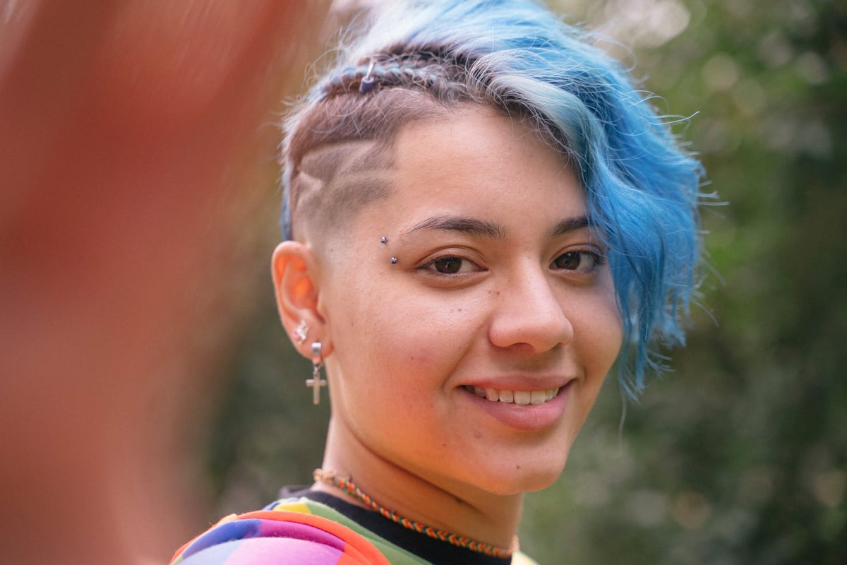 Androgynous Woman with Trendy Hairstyle Smiling Closeup Portrait